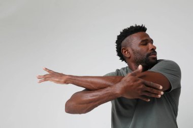 African American athletic man doing muscle stretching exercises. Mock-up. High quality photo.