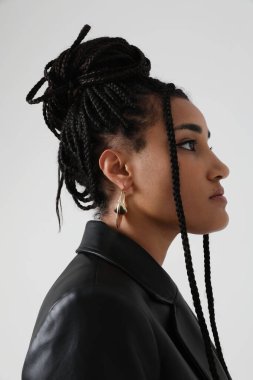 African American young woman with long dark braids, posing indoor. Mock-up. High quality photo