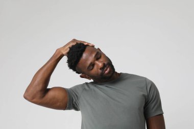 African American athletic man doing neck stretching exercises. Mock-up. High quality photo.