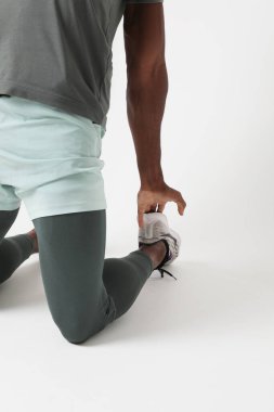 Cropped photo of athletic man doing muscle stretching exercises. Vertical. High quality photo.