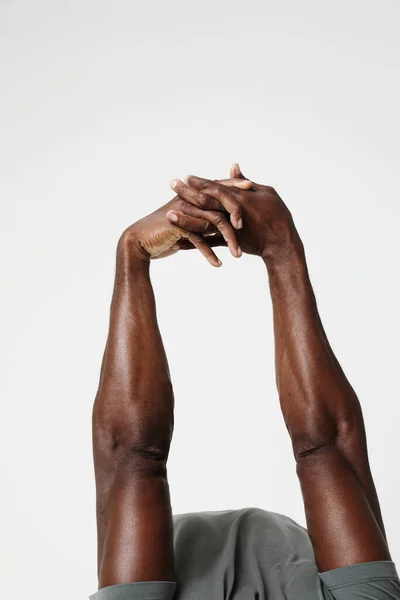 Cropped photo of athletic black man doing muscle stretching exercises. Vertical. High quality photo.