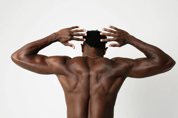 African American athletic young man with doing muscle exercises. Mock-up. High quality photo.