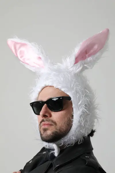 Young Bearded Man Wearing Bunny Ears Sunglasses Posing Indoor Vertical Stock Photo
