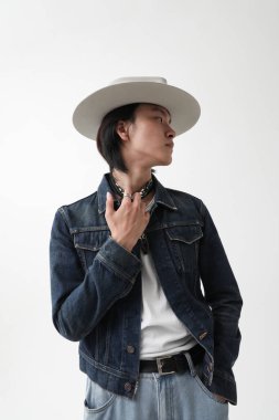 Beyaz arka planda kapalı alanda poz veren, kendine güvenen Asyalı yakışıklı bir adam. Yüksek kalite fotoğraf.