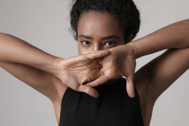 Close-up portrait of African American young woman looking at the camera. Mock-up. High quality photo.