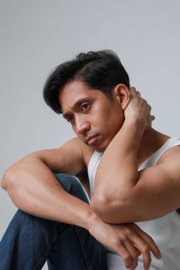 Beyaz arka planda poz verip kameraya bakan Asyalı adamın portresi. Yüksek kalite fotoğraf