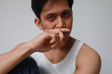 Beyaz arka planda poz verip kameraya bakan yakışıklı Asyalı adamın portresi. Yüksek kalite fotoğraf.