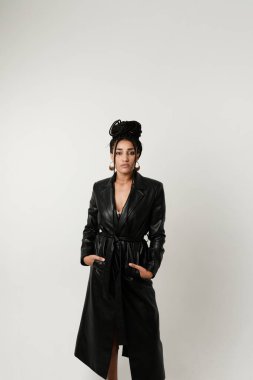 Beyaz arka planda kalan uzun siyah örgülü Afro-Amerikalı genç bir kadının dikey portresi. Yüksek kalite fotoğraf.