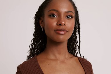 Genç ve güzel dişinin koyu teni var, beyaz arka planda izole edilmiş ve sağ tarafında fotokopi alanı var. Yüksek kalite fotoğraf.