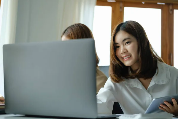 stock image Negotiation, Analysis, Discussion, Portrait of an Asian woman economist and marketer using computer laptop to plan investments and financial to prevent risks and losses for the company.