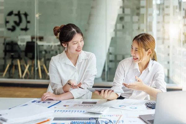 stock image Negotiation, Analysis, Discussion, Portrait of an Asian women economist and marketer using tablet computer to plan investments and financial to prevent risks and losses for the company.