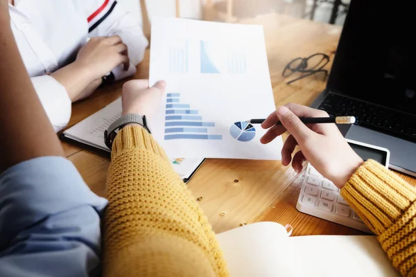 Stock image The auditor hand holding pen and budget graph document to examine the misuse of company funds