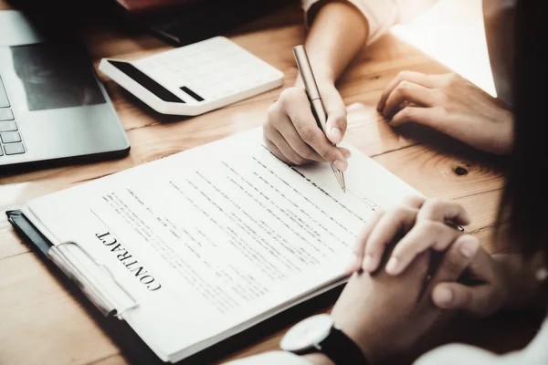 stock image Business owner holding a pen to read the conditions to enter into a joint venture contract with a partner company