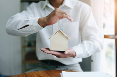 Asyalı bir adamın portresi, Ajan, arazi alıp satma, emlak vergisi, eve zarar verme riskini karşılamak için evi koruma kavramını gösteriyor..