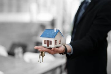 Muhasebeci, işadamı, emlakçı, Asyalı iş adamı model ev ve müşterilere ev faizi hesaplama belgeleriyle birlikte müşterilerin imzalaması için anahtarları veriyor..
