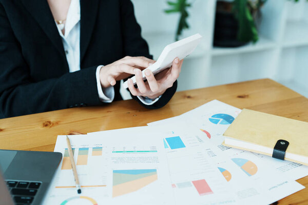 financial, Planning, Marketing and Accounting, portrait of Asian employee checking financial statements using documents and calculators at work..