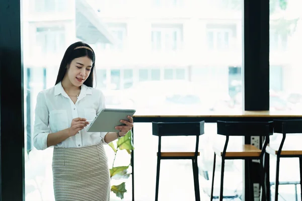 stock image Portrait of a beautiful Asian teenage girl using a tablet computer.