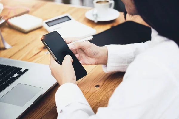 stock image woman using mobile phone and computer to work in home office