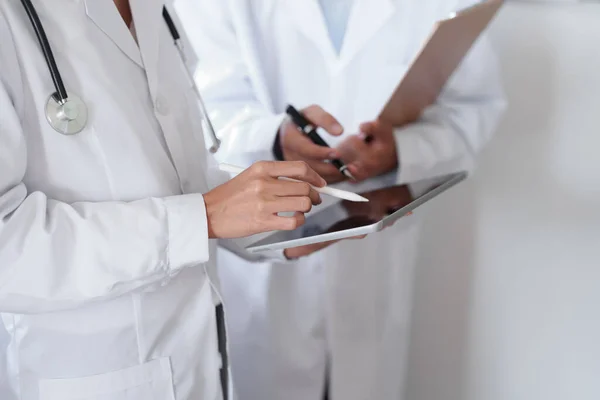 stock image Portrait of an Asian female doctor and male doctor using a tablet to discuss patient problems before treatment.