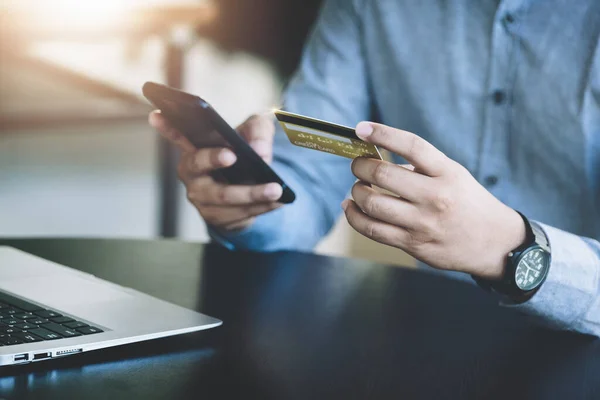 stock image Online Shopping and Internet Payments, Asian man are using their credit card and mobile phone to shop online or conduct errands in the digital world