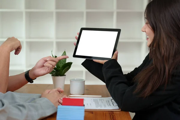 Bank officer, real estate employee talking to spouse, see information in Tablet computer about interest rates for home loan in the office, loan, insurance, financial risk management concepts.