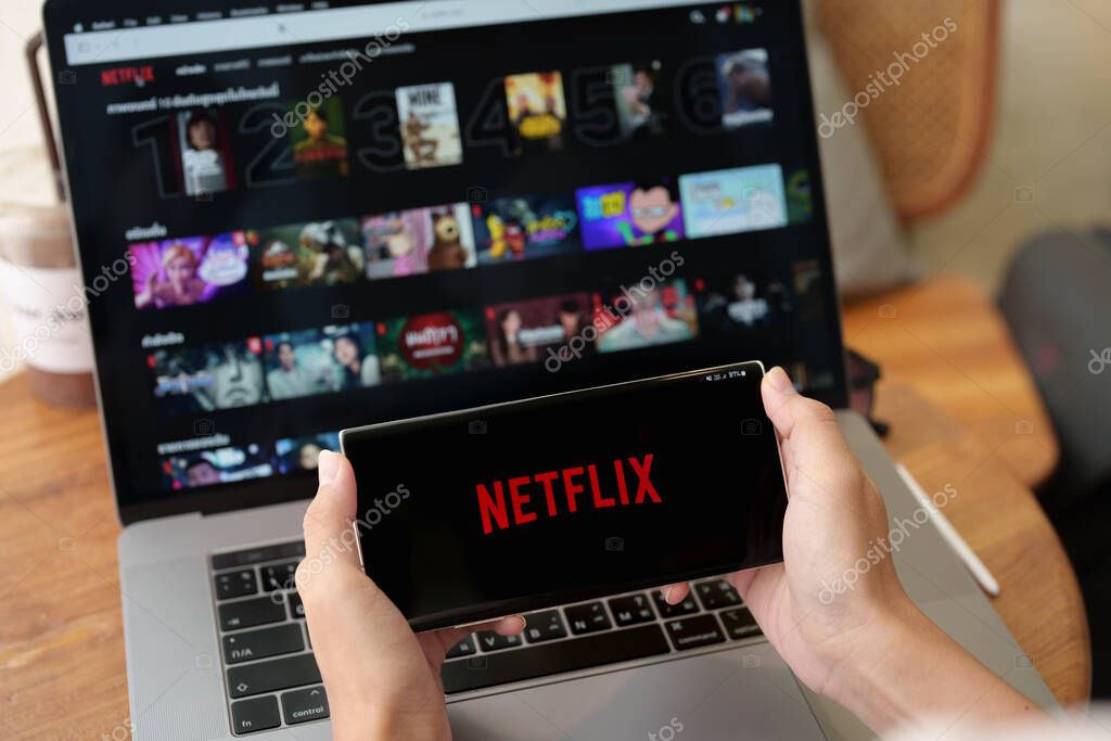 CHIANG MAI, THAILAND, Jul 09 , 2022: Woman hand holding Smart Phone with Netflix logo on android phone. Netflix is a global provider of streaming movies and TV series.