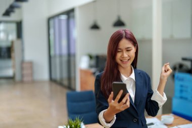 İş adamları ortaklarıyla iletişim kurmak için akıllı telefonu kullanır, başarı kavramı.