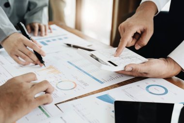 Yatırım risklerini azaltmayı planlayan bir grup iş adamının ortaklarla birlikte çalıştığı imajı, toplantılarda kârlı ve hedeflenmiş müşteri ihtiyaçlarını analiz etmek üzere pazarlama stratejilerini ayarlıyor.