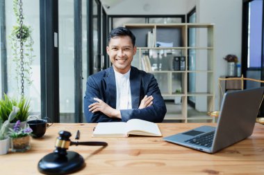 Portrait of a Asian man lawyer studying a lawsuit for a client before going to court.