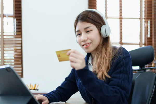 Online Shopping and Internet Payments, Beautiful Asian women are using their credit cards and tablet computer laptop to shop online or conduct errands in the digital world.