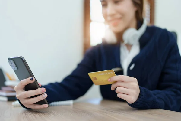 Online Shopping and Internet Payments, Asian man are using their credit card and mobile phone to shop online or conduct errands in the digital world