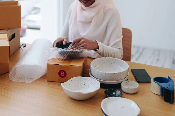 Beautiful Muslim woman selling online at home, business owner, business sme concepts.