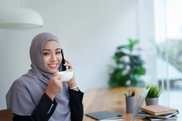 Красивая Мусульманская Женщина Разговаривает Телефону Помощью Компьютера Вершине Время Работы — стоковое фото