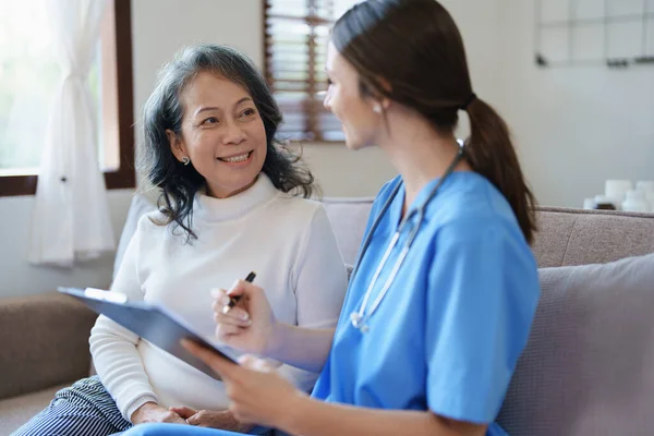stock image Portrait of a female doctor holding a patient clipboard to discuss and analyze the patients condition before treating