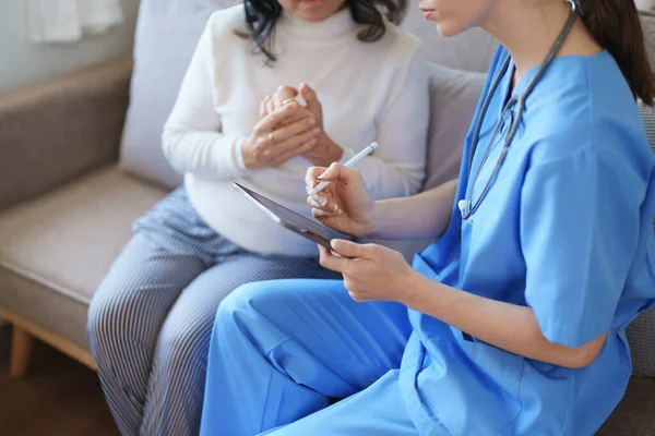 Portrait of a female doctor holding tablet computer to discuss and analyze the patients condition before treating