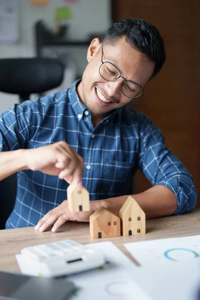 stock image Entrepreneurs, business owners, accountants, real estate agents, A young man using a calculator to calculate his home budget to assess the risks of investing in real estate.