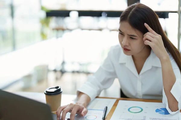 Stock image Portrait of sme business owner, woman using computer and financial statements Anxious expression on expanding the market to increase the ability to invest in business.