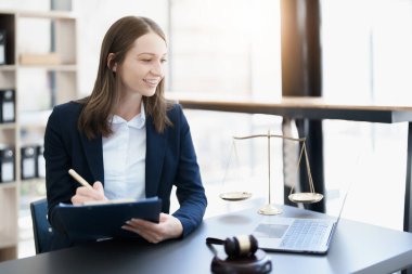 Portrait of a Asian woman lawyer studying a lawsuit for a client before going to court.