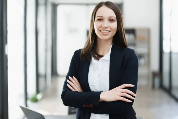 stock image Portrait of a woman business owner showing a happy smiling face as he has successfully invested her business using computers and financial budget documents at work.