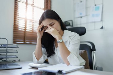 Sme işletme sahibi, bilgisayar ve finansal tabloları kullanan kadın, piyasanın genişletilmesi konusunda endişeli ifade, iş dünyasına yatırım yapma yeteneğini artırmak için.