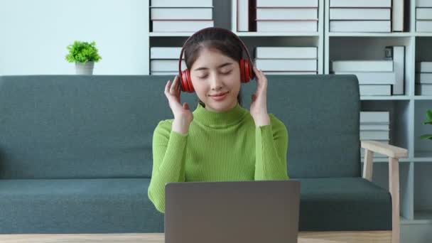 Young Asian Woman Putting Headphones Showing Smiling Face Using Computer — Stock Video