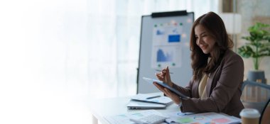 Ofis içinde siyah takım elbiseli bir iş kadını tablet bilgisayar kullanıyor, müşterilerin iletişim kurması için denetleme evrakları, iş adamları kavramı