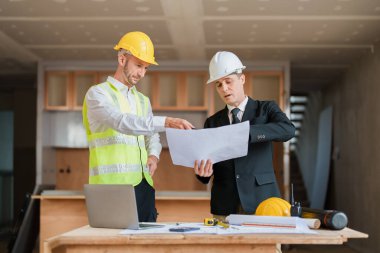 Çok ırklı mühendis, bina ve evler için mimari ve mühendislik tasarımı hakkında planlar ve kat planı çizimlerinin maliyet tahmini için beyin fırtınası ve ölçümlemesi.