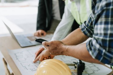 Çok ırklı mühendis, bina ve evler için mimari ve mühendislik tasarımı hakkında planlar ve kat planı çizimlerinin maliyet tahmini için beyin fırtınası ve ölçümlemesi.