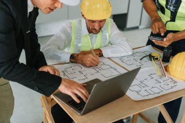 Evler ve binalar için mimari ve mühendislik tasarımı hakkında kağıt işleri ve zemin planı çizimlerinin maliyet tahmini için çok ırklı mühendis beyin fırtınası ve ölçümü.