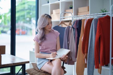 Asyalı Kadın Moda Mağazası 'nın Portresi Giyim Mağazasında Hisse Kontrol Dükkanı Küçük işletme, sme veya ecommerce kavramlarına başarılı bir gülümseme ile.