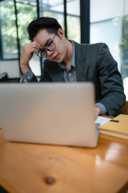 İşletme sahibinin portresi, bilgisayar ve finansal tabloları kullanan adam piyasanın genişletilmesi konusunda endişeli ifade iş dünyasına yatırım yapma becerisini artırmak için
