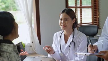 Genç Asyalı kadın doktor bir hastaya danışmanlık yapıyor. Yüksek kalite 4k görüntü