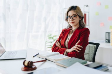 Portrait of a Asian woman lawyer studying a lawsuit for a client before going to court.