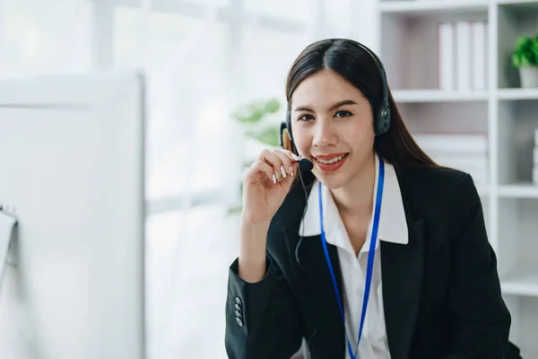 young business woman wear wireless headset video conference calling on laptop computer talk by webcam discussing in online meeting about budget and profit of company.
